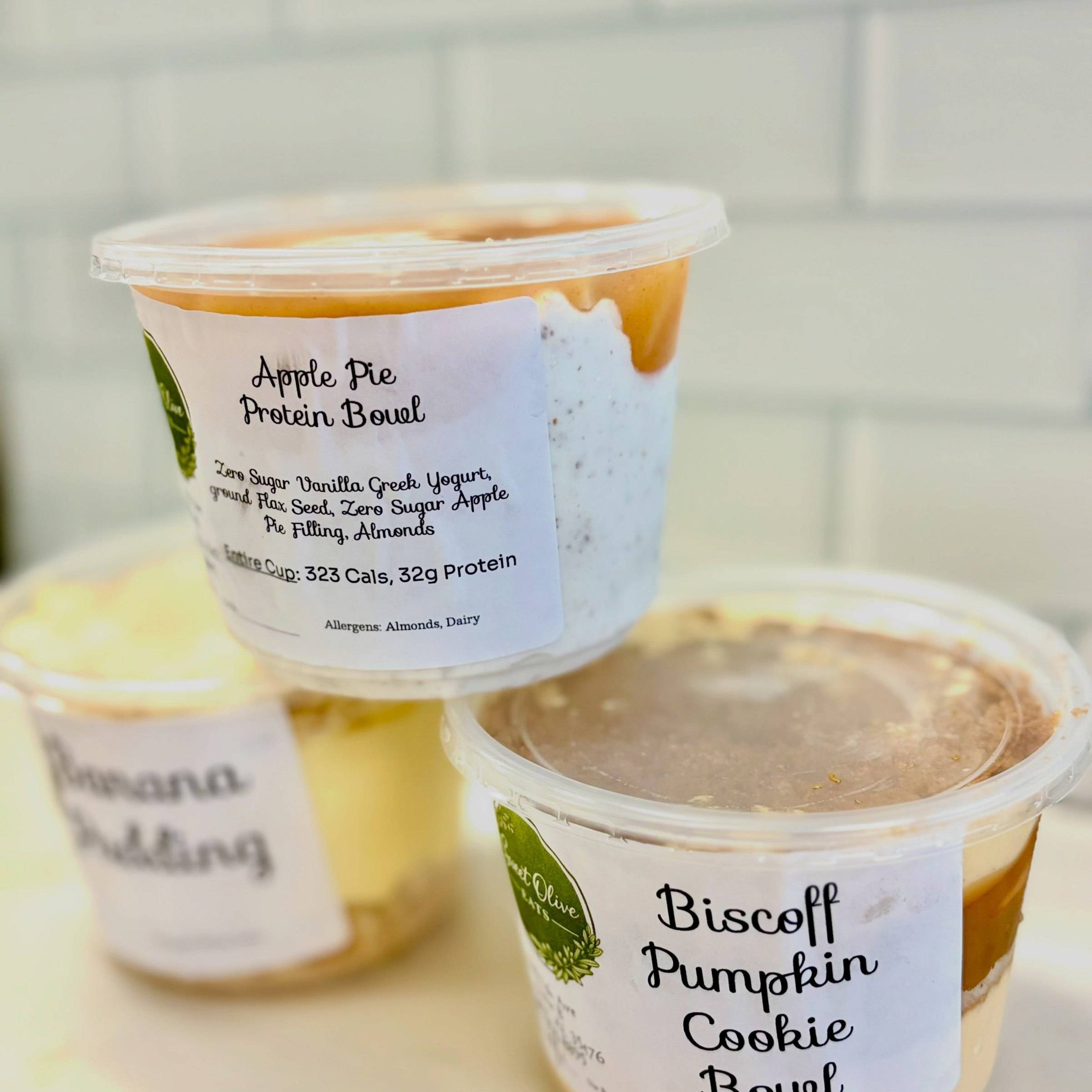 Apple Pie Protein Bowl, Banana Pudding and Biscoff Pumpkin Cookie Bowl cups with Sweet Olive labels